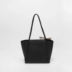 Close-up of black lychee grain leather tote bag with elegant silk scarf accessory