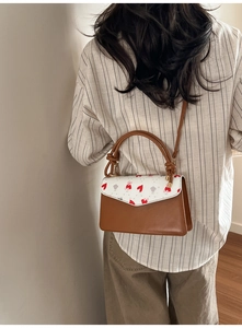 Model view of women's crossbody bag with bear prints and decorative knot handle