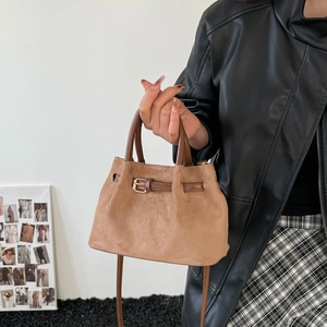Brown frosted leather bucket bag with gold hardware and adjustable crossbody strap