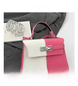 Detail of pink and white lychee leather texture on trapezoid bag with silver twist lock