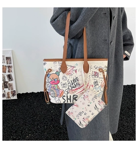 Detail shot of white graffiti tote bag with brown straps worn by a model in a side view