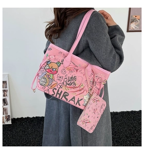 Pink graffiti tote bag set with cartoon bear print and small pouch on female model