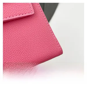 Detailed macro view of pink lychee grain leather with precise white stitching craft