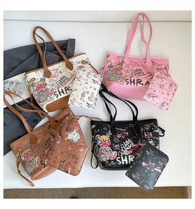 Close-up of four colorful tote bags with graffiti prints and matching small pouches