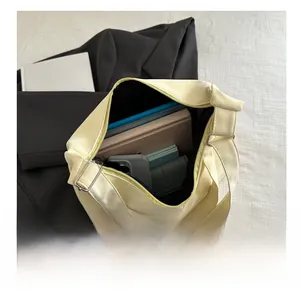 Detailed interior view of a cream PU leather tote bag showing large storage capacity