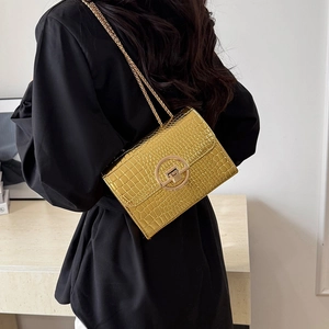 Golden crocodile pattern crossbody bag with round metal buckle and elegant chain strap