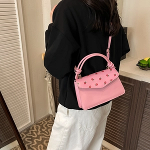 Pink strawberry print faux leather crossbody bag with top handles and adjustable strap