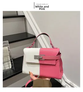 Detailed view of the pink and white color-block leather bag with a silver metal clasp