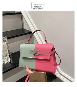 Detail view of contrast color trapezoid bag with lychee texture and silver twist lock