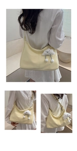 Detail of soft cream yellow PU leather tote bag with cloud plush charm and stitching