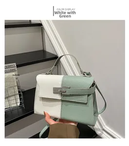 Detail of white and sage green leather shoulder bag with a silver metal clasp lock
