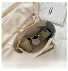 Internal view of large capacity tote bag showing phone, water cup, and sunglasses