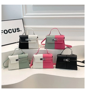 Detail view of five minimalist contrast color trapezoid handbags with metal twist locks