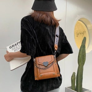 Brown retro crossbody bag for women with heart detail and ethnic style strap