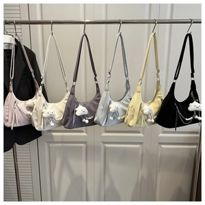 Selection of colorful crescent shoulder bags with silver chains and plush charms