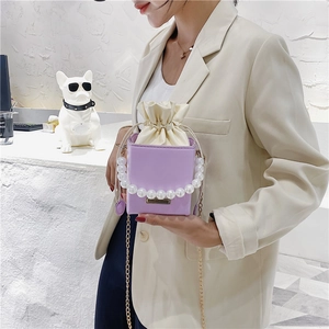 Stylish purple mini bucket bag with large pearl handle and metal chain shoulder strap