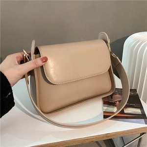 Minimalist beige faux leather baguette shoulder bag with adjustable strap and gold hardware