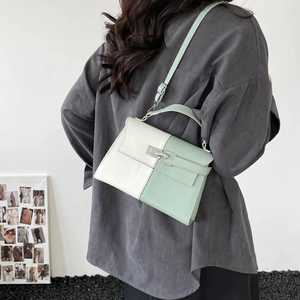 Chic two-tone crossbody bag in cream and light green leather with metal turn-lock closure