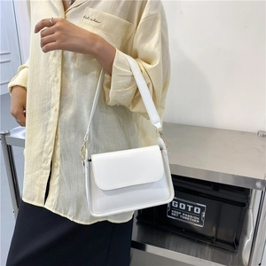 Chic white PU leather crossbody bag with wide shoulder strap and gold metallic buckle