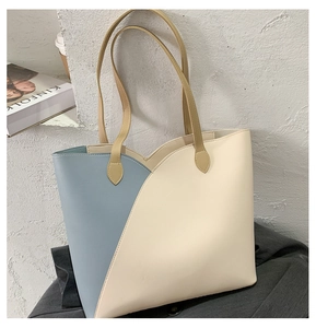 Detail of blue and beige contrast tote bag showing high-quality synthetic leather texture