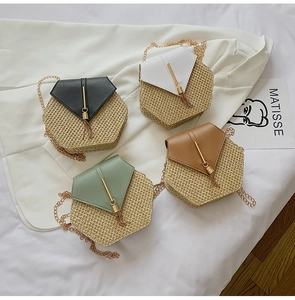 Macro detail of hexagonal straw woven chain bags with leather tassels and gold hardware