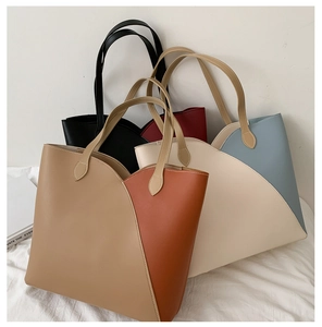Detail view of large PU leather tote bags in khaki, beige, black and burgundy colors