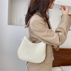 Minimalist cream white crescent underarm bag with smooth leather and adjustable strap