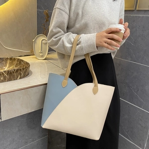 Minimalist large-capacity tote bag in light blue and beige patchwork for urban commuters