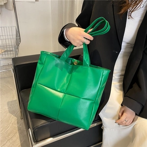 Bright green quilted leather tote bag with oversized check pattern and long handles