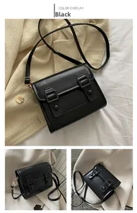 Détail du petit sac bandoulière noir en simili cuir avec boucles et ferrures dorées