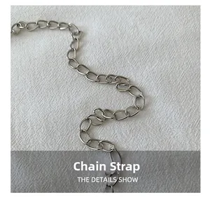 Detailed close-up of glossy silver metal chain shoulder strap for fashion handbags