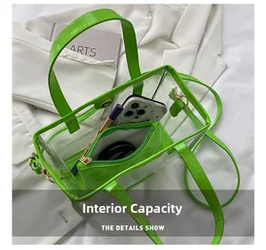 Detail of clear green PVC tote bag with leather handles showing internal storage capacity