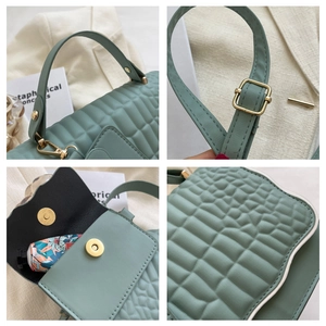 Detail shots of mint green pleated PU leather bag with gold hardware and magnetic closure