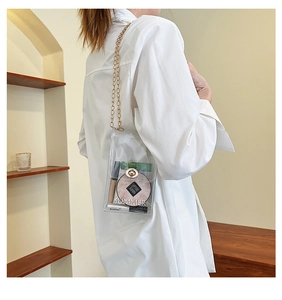 Detail of transparent PVC crossbody bag with gold chain strap and Summer print