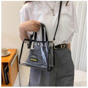 Detailed macro view of a clear PVC tote with a black inner pouch and shoulder strap