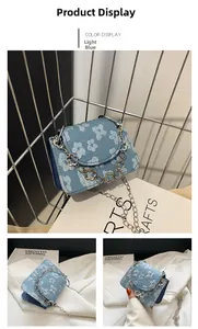 Detail of light blue floral jacquard mini bag featuring decorative metal flower chain