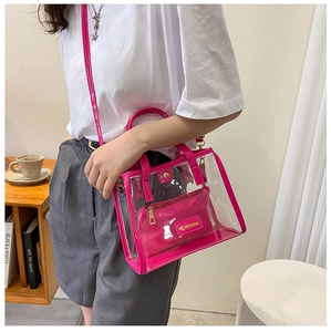 Detailed side view of a magenta transparent jelly tote bag shown in a lifestyle scene