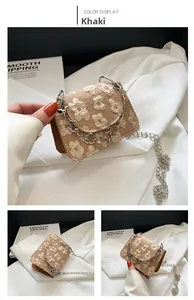Close-up of khaki mini crossbody bag with floral embroidery and silver chain strap