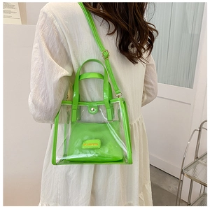 Detail of transparent PVC tote with neon green inner pouch and adjustable strap