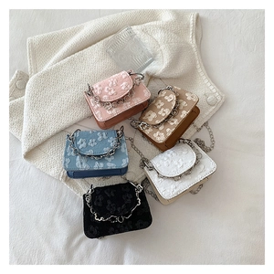 Detailed flat lay of floral jacquard mini crossbody bags with silver chain straps in five colors
