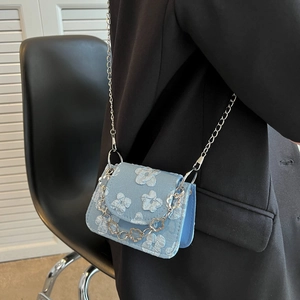 Blue jacquard mini crossbody bag with white 3D floral embroidery and silver chain strap