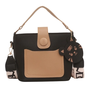 Chic black and brown contrast crossbody bag with a wide patterned shoulder strap and tiger charm