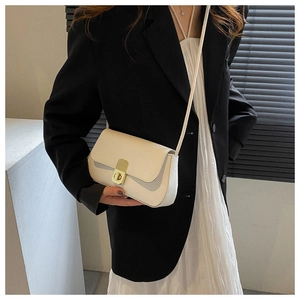 Minimalist white leather crossbody bag with golden rectangular lock on model