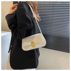 Side view of white rectangular shoulder bag with golden twist lock and knotted strap