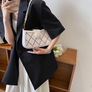 White quilted crossbody bag with brown lattice pattern and braided shoulder strap