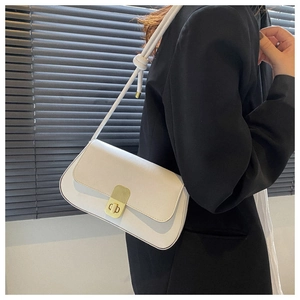 Close-up of white vintage flap bag with gold twist lock and knot strap detail