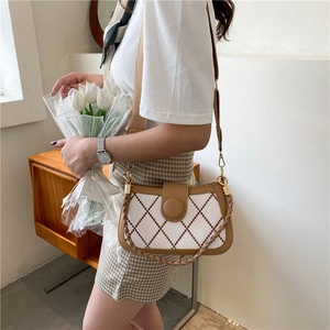Chic quilted crossbody bag in beige and brown leather with wide canvas shoulder strap