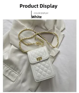 Detail of white quilted crossbody bag with golden twist lock and metal chain strap
