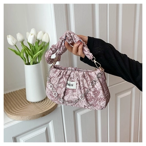 Détail du sac hobo plissé lavande avec chaîne fleurie et poignée à texture gaufrée