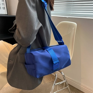Blue waterproof nylon crossbody bag with wide adjustable strap for sports and leisure